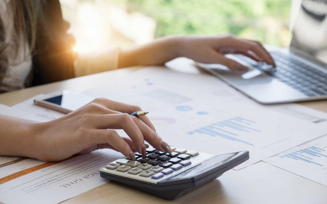 basDollars and Sense Consulting - Australian Bookkeeper - multitasking calculator and laptop